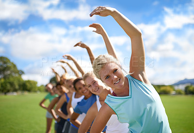 Buy stock photo Women stretching, team outdoor and exercise on sports field, fitness class and physical activity. Health, portrait and training together, young athlete group workout in park and warm up with wellness
