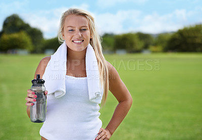 Buy stock photo Happy woman, portrait and water with towel in fitness on green grass for workout, exercise or outdoor training. Face of female person or blonde with drink or mineral liquid for natural sustainability