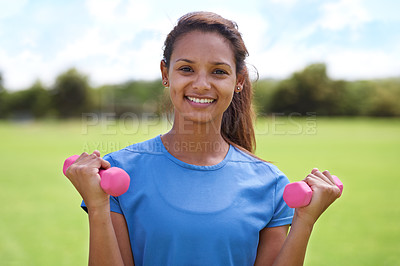 Buy stock photo Woman, portrait and dumbbell outdoor for exercise with smile for workout, training or fitness on sports field. Athlete, person and happy for physical activity or healthy body on grass with equipment