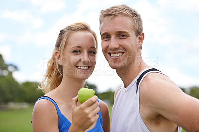 Buy stock photo Couple, sport and portrait with apple, fitness and exercise on a field with a smile and wellness. Happy, healthy and athlete outdoor with fruit, nutrition and health together for workout and training