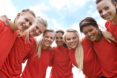 Buy stock photo Portrait of an all-girls soccer team standing arm in arm outside