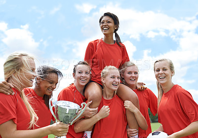 Buy stock photo Trophy, winner and girl soccer team celebrating victory, achievement and match success on field. Football, prize and female teenage sports group lifting champion for celebration, competition or goal