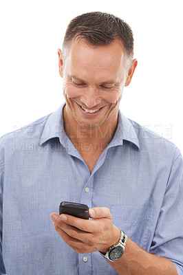 Buy stock photo Typing, business man and phone in studio isolated on a white background for social media. Technology, smartphone and mature male entrepreneur happy with cellphone for networking or text messaging.