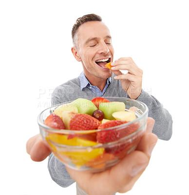 Buy stock photo Happy man eating fruits isolated on a white background for healthy green lunch, diet offer or nutritionist breakfast. Professional vegan person or model giving fruits salad, food or peach in studio