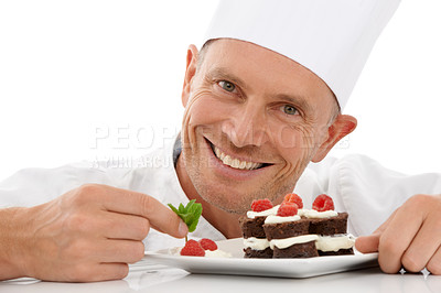 Buy stock photo Bakery, baking and portrait of a chef with cake presentation isolated on a white background in a studio. Fruit, food and face of a professional baker with a sweet chocolate dessert for catering