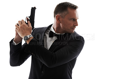 Buy stock photo Spy, gun and secret agent model with isolated, white background and mockup ready for action. Actor, weapon and tuxedo suit of a man looking mysterious with classy style and pistol for danger
