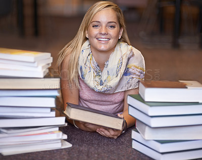Buy stock photo Happy woman, portrait and book on library floor for reading, literature or learning knowledge at bookstore. Female person, bookworm or student smile for information, story or research on author