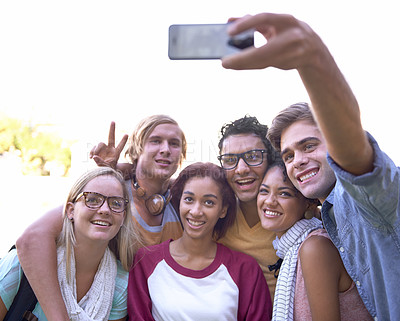 Buy stock photo Students, selfie and cellphone on campus with smile, together and wellness at university for online post. Friends, smartphone or diversity in education or study group in profile picture by outdoor