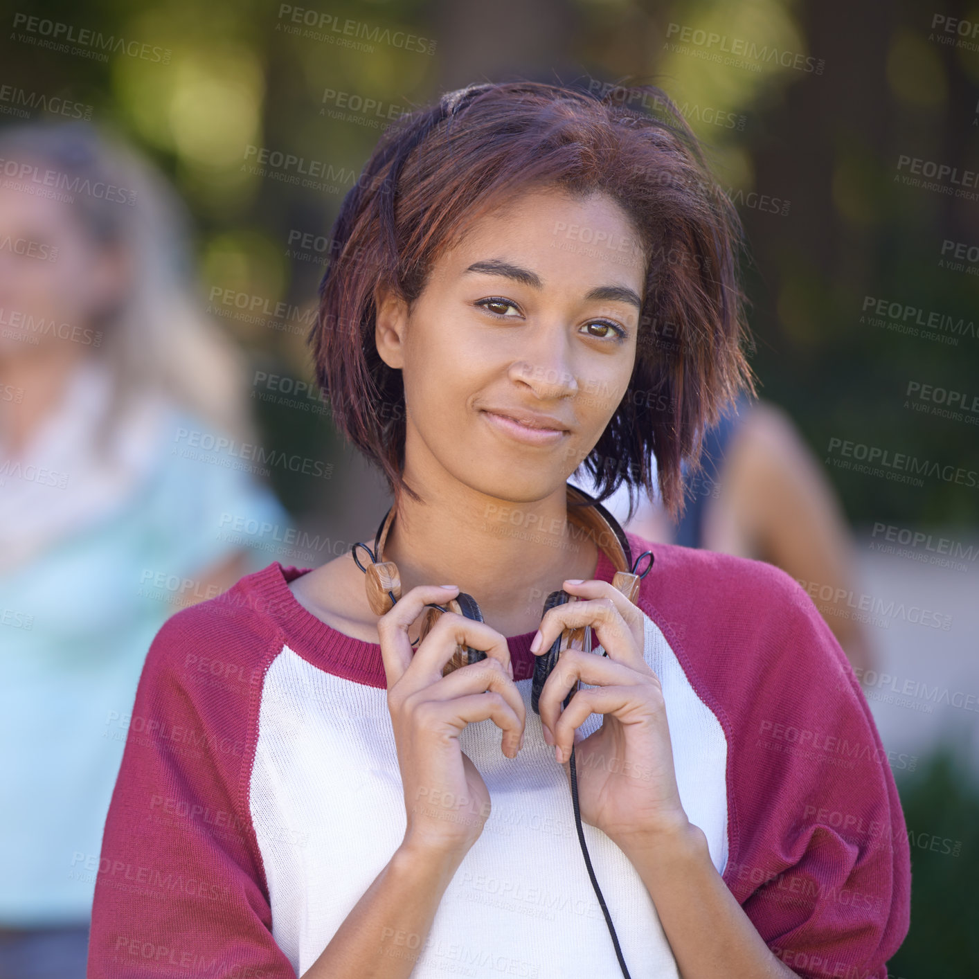 Buy stock photo Young woman, headphones and portrait on campus, happy and nature with scholarship at college. Student, smile and face by audio electronics, music and university outdoor for streaming podcast at park