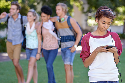 Buy stock photo Young woman, headphones and cellphone on campus, typing and break with wellness at college. Student, smile and smartphone on social media on internet, technology and university outdoor for connection