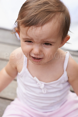 Buy stock photo Sad baby, face and sitting outside of curious toddler, little girl or disappointed on outdoor porch. Closeup of young unhappy child, upset kid or adorable cute newborn with frowning facial expression