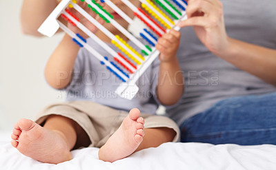 Buy stock photo A mother and her toddler son counting on an abacus