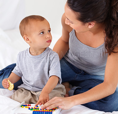 Buy stock photo Abacus, bonding and baby with mother playing, learning and teaching for child development on bed. Math, toy and closeup of mom helping kid, infant or toddler with counting in bedroom at home.