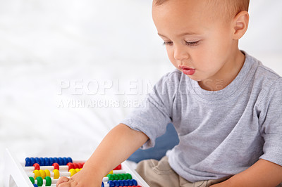 Buy stock photo Abacus, math and boy baby learning, playing and teaching for child development on bed. Preschool, youth and closeup of kid, infant or toddler with counting for toy in bedroom or nursery at home.