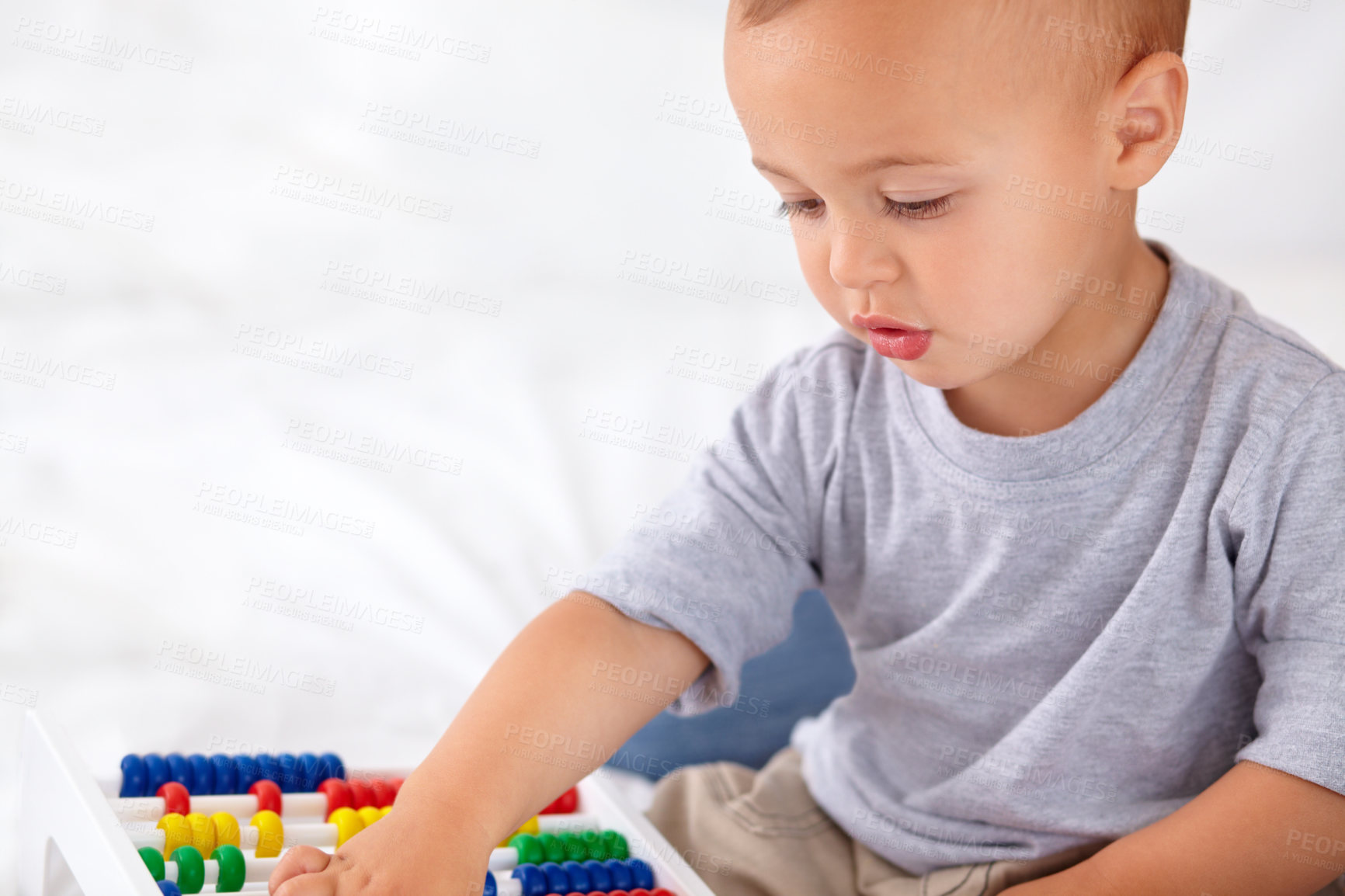 Buy stock photo Abacus, math and boy baby learning, playing and teaching for child development on bed. Preschool, youth and closeup of kid, infant or toddler with counting for toy in bedroom or nursery at home.