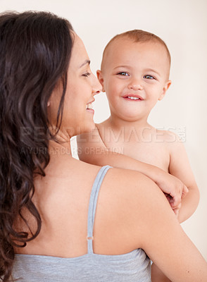 Buy stock photo Family, happy and mother with child on a white background for bonding, relationship and relax together. Love, youth and portrait of mom carrying kid for growth, playing and development in studio