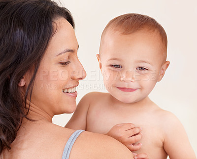 Buy stock photo Family, love and mother with baby on a white background for bonding, relationship and relax together. Happy, youth and mom carrying kid for childcare wellness, playing and development in studio