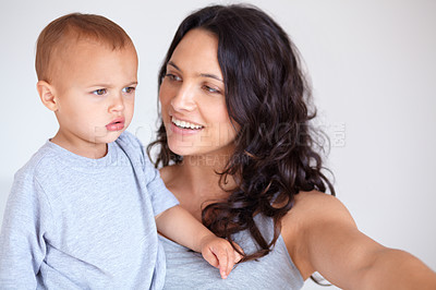 Buy stock photo Mom holding toddler in bedroom with smile, bonding and child care with support in morning. Happy woman, baby boy and spending time together in home with development, trust and safety in mothers love.