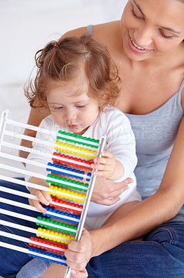 Buy stock photo Abacus, education and baby with mother playing, learning and teaching for child development on bed. Bonding, toy and closeup of mom helping kid, infant or toddler with counting in bedroom at home.