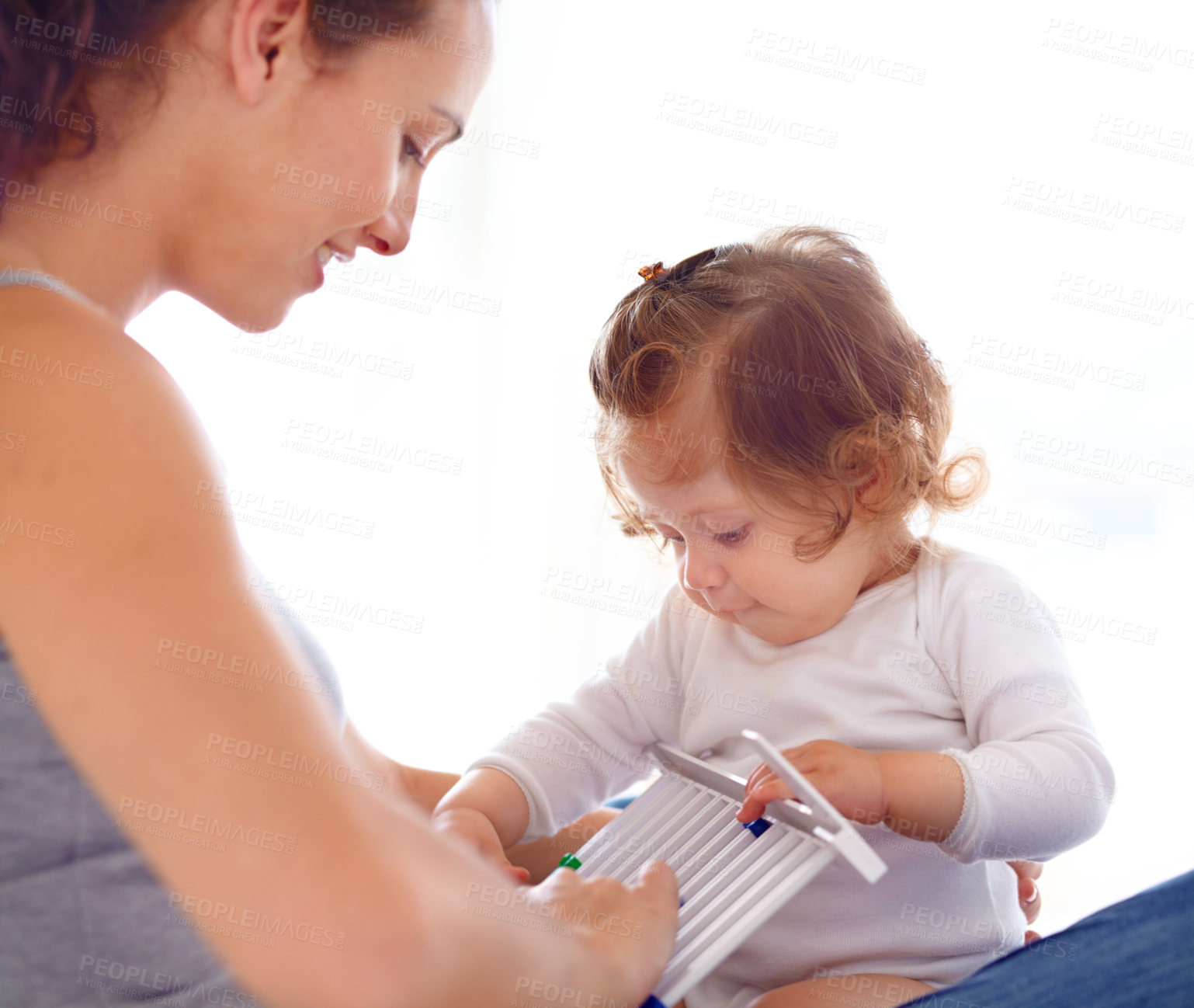 Buy stock photo Mom playing with baby girl in home with toys, bonding and child care with support in morning on bed. Happy woman, playful toddler and fun together in bedroom with development, smile and abacus