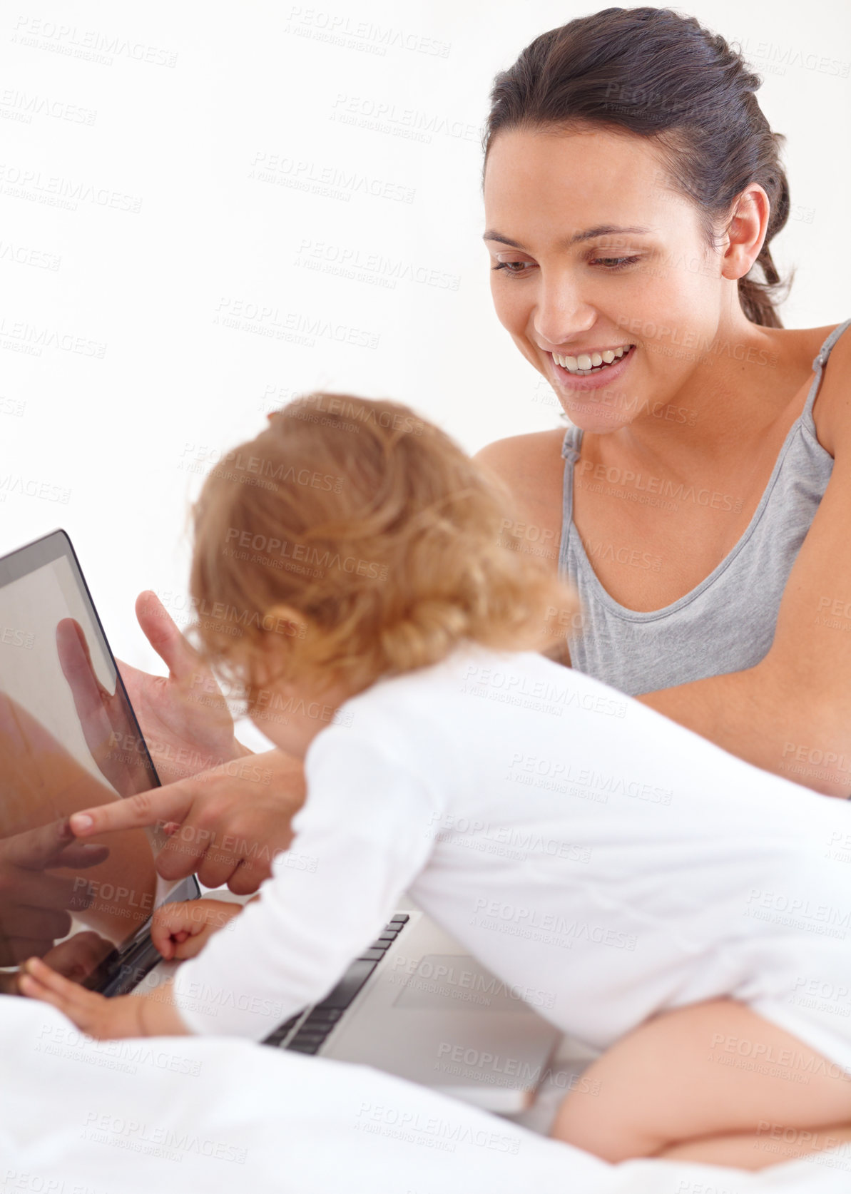 Buy stock photo Learning, baby and smile of mother on laptop in bedroom for online education or remote work in home. Freelancer mom, computer and point to kid on internet, show toddler screen and family together