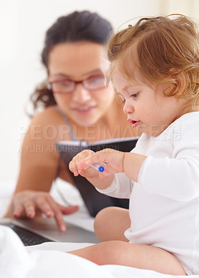 Buy stock photo Mom, working and multitasking on laptop with baby in home for remote work or writing project. Infant, kid and mother busy with freelance productivity on computer and child in bedroom playing with pen