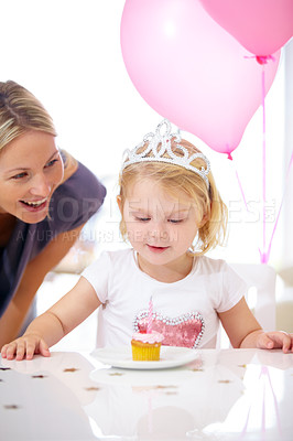 Buy stock photo Birthday, girl and mother with cupcake, candle and balloons for party, celebration and fun. Toddler with princess tiara, cake or dessert and woman with child at family home for milestone and event