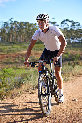 Buy stock photo Man, cycling and exercise on bike in nature for journey and adventure in countryside. Athlete, workout and person riding on bicycle for cardio and fitness on dirt road, trail or path in the woods