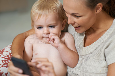 Buy stock photo Mother, baby and phone or smile with internet for social media, video streaming or cartoons for development. Family, woman and toddler or child with smartphone for scroll, search and entertainment