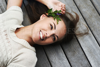 Buy stock photo Woman lying on her porch, funny and summer with smile, happiness and chilling on a weekend break. Person, outdoor or girl with holiday, cheerful and flowers in her hair, relax or floral with vacation