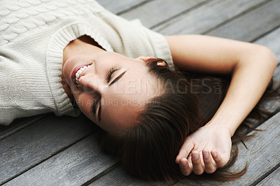 Buy stock photo An attractive young woman lying on her porch