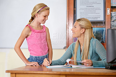 Buy stock photo Teacher, student and grading paper in class, education and learn with portfolio, mark test or feedback. Teaching for development, exam and study, explain subject with woman and girl kid in classroom