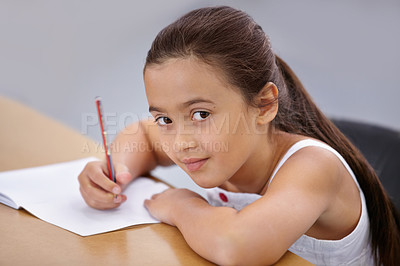 Buy stock photo Portrait, kid and education of student taking notes in classroom for knowledge and development. Serious, girl and learner writing in notebook, studying or learning in middle school class in Spain.