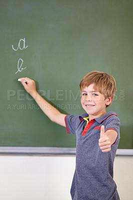 Buy stock photo Portrait, child writing or thumbs up on chalkboard in classroom of elementary school. Boy, education student or happy kid with smile or hand gesture for like emoji, agreement or learning to write