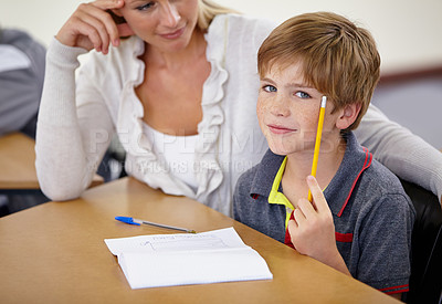 Buy stock photo Teacher woman, classroom and boy at desk in portrait with support, advice and knowledge for education. People, learning and development for person, child and pencil for progress, school or academy
