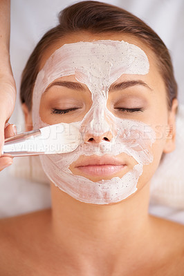 Buy stock photo Closeup of a beauty therapist applying a face mask to a client