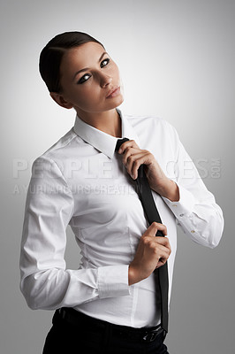 Buy stock photo Portrait, business and woman fix tie in studio isolated on a gray background. Confidence, female person and adjust necktie, shirt for style and beauty of serious fashion model in clothes in Brazil