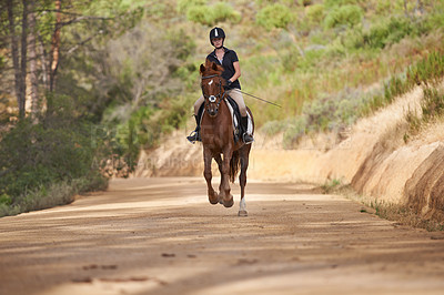 Buy stock photo Equestrian, trail and riding a horse in nature on adventure and journey in countryside. Ranch, animal and rider outdoor with pet on path in forest or woods for hobby on farm with girl in summer