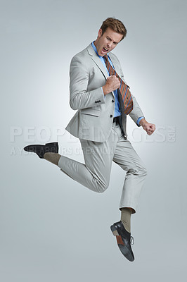Buy stock photo Shot of a young businessman wildly celebrating his success