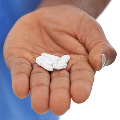 Buy stock photo Cropped view of a man's hand holding out some white pills