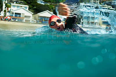 Buy stock photo Swimming, crawl and person in ocean water in summer for exercise, training or workout on mockup space. Sea, sport and an athlete stroke outdoor for fitness, health and triathlon competition in nature