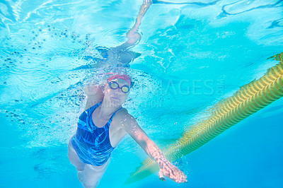 Buy stock photo Underwater, woman and swimming with health, stroke and sports with exercise, wellness and active. Person, wet and athlete with competition, hobby and indoor pool with wellness, breathing and splash