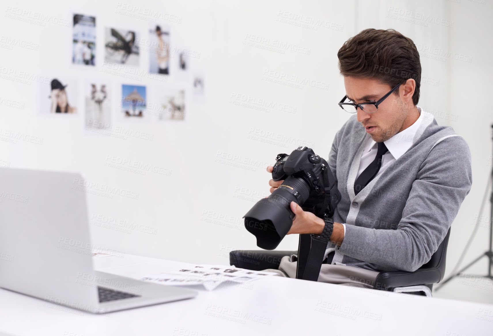 Buy stock photo Man, camera and photography in office with laptop, checking image batch and creative in workplace. Person, thinking and glasses for vision, technology and focus in agency with professional career