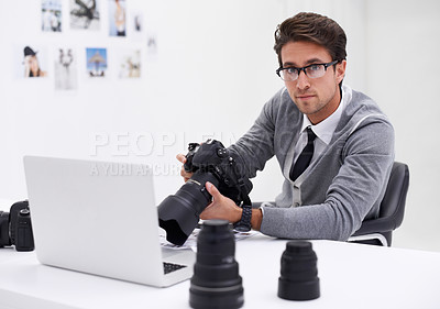 Buy stock photo Man, photographer and portrait with laptop, camera and lens for work, shoot and editing photographs. Professional, office and technology with creativity, internet and equipment for videography