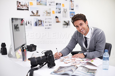Buy stock photo Man, camera and photography in agency with portrait, checking image design and creative in workplace. Person, smile face and glasses for vision, technology and focus in office with digital photoshoot