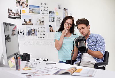 Buy stock photo Camera, office and photographers looking at photoshoot in a studio or workshop for production. Creative, photography and team of young artists with dslr equipment for picture inspection in workplace.
