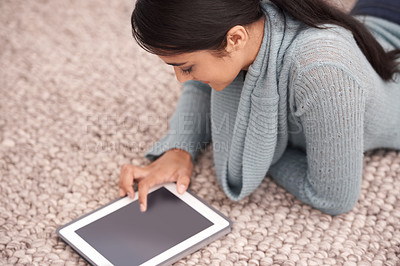 Buy stock photo Woman on floor with tablet, smile and relax with studying, research and social media post in living room. Happy student girl on carpet with digital app, elearning and reading blog online in home.