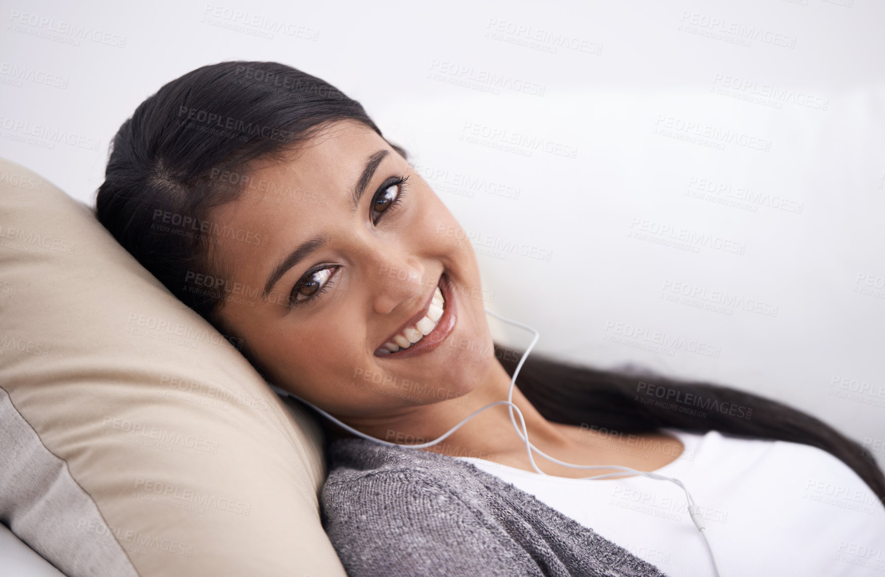 Buy stock photo Portrait of happy woman on sofa with smile, headphones and relax with mobile app for podcast in house. Face of girl lying on couch with earphones, music and streaming service for online radio in home