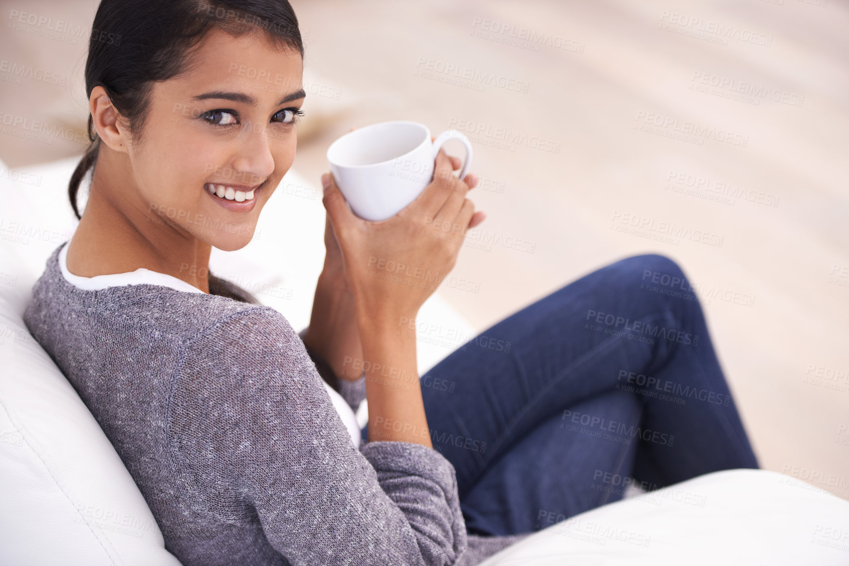 Buy stock photo Coffee, living room and portrait of Indian woman on sofa for relaxing, comfortable and calm in home. Apartment, morning and happy person with mug on couch drinking hot beverage, tea and caffeine