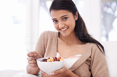 Buy stock photo Happy woman, portrait and fruit bowl for diet, nutrition or snack sitting on sofa at home. Face of young female person, nutritionist or vegan smile with healthy breakfast for vitamin c, salad or meal